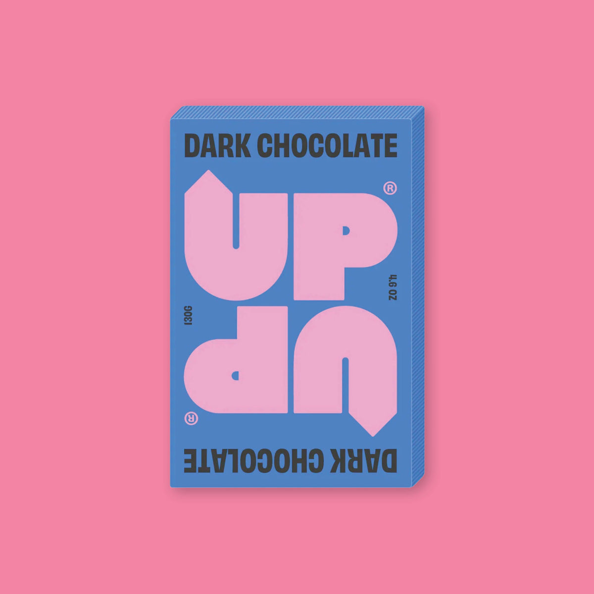 On a bubblegum pink background sits a box of UP UP Dark Chocolate. The packaging is in blue, lavender, and black. 130G 4.6 OZ