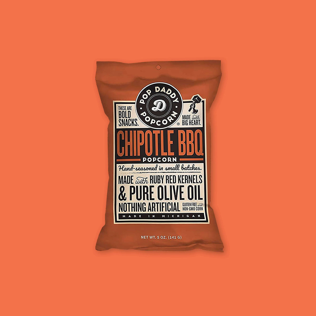 On an orangey-red background sits a package. This package is rust colored with a cream label. There is copy in black and rust. It says "POP DADDY POPCORN," "THESE ARE BOLD SNACKS," "MADE with BIG HEART," "CHIPOTLE BBQ POPCORN," "Hand-seasoned in small batches," " MADE with RUBY RED KERNELS & PURE OLIVE OIL NOTHING ARTIFICIAL GLUTEN FREE and NO-GMO CORN," "MADE IN MICHIGAN." NET WT. 3 OZ. (85 G)
