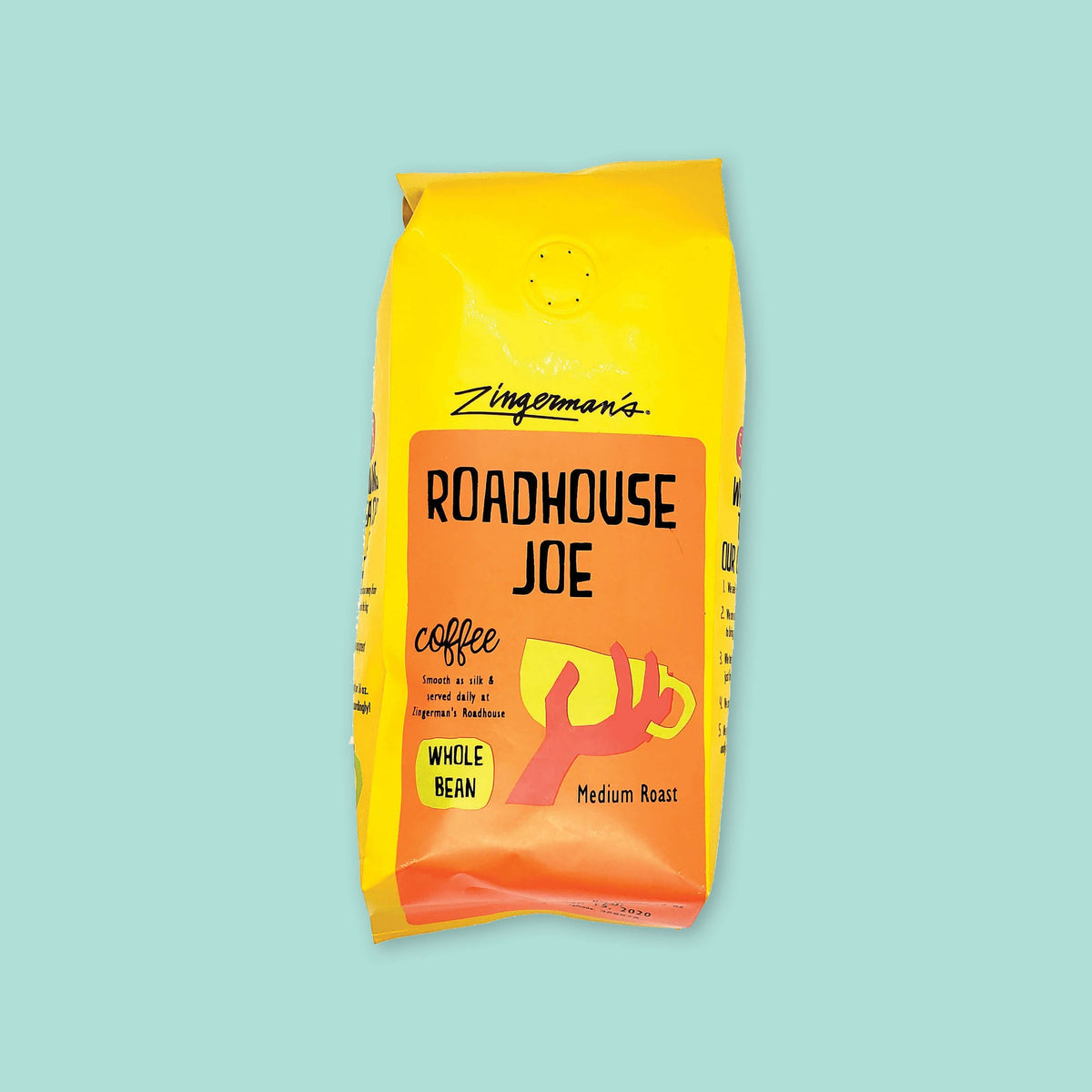 On a cool aqua background is a yellow bag of coffee. The coffee is Zingerman's brand Roadhouse Joe Blend. 'Smooth as silk and served daily at Zingerman's Roadhouse' Ground coffee. 12 oz (350 g)