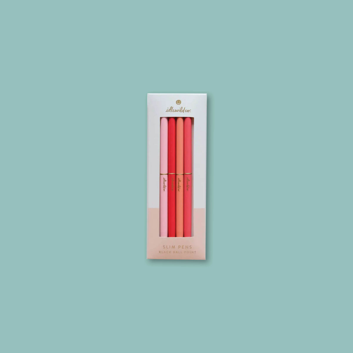 On a turquoise background sits a 4-count set of Idlewild Co. Slim Pink Pens.