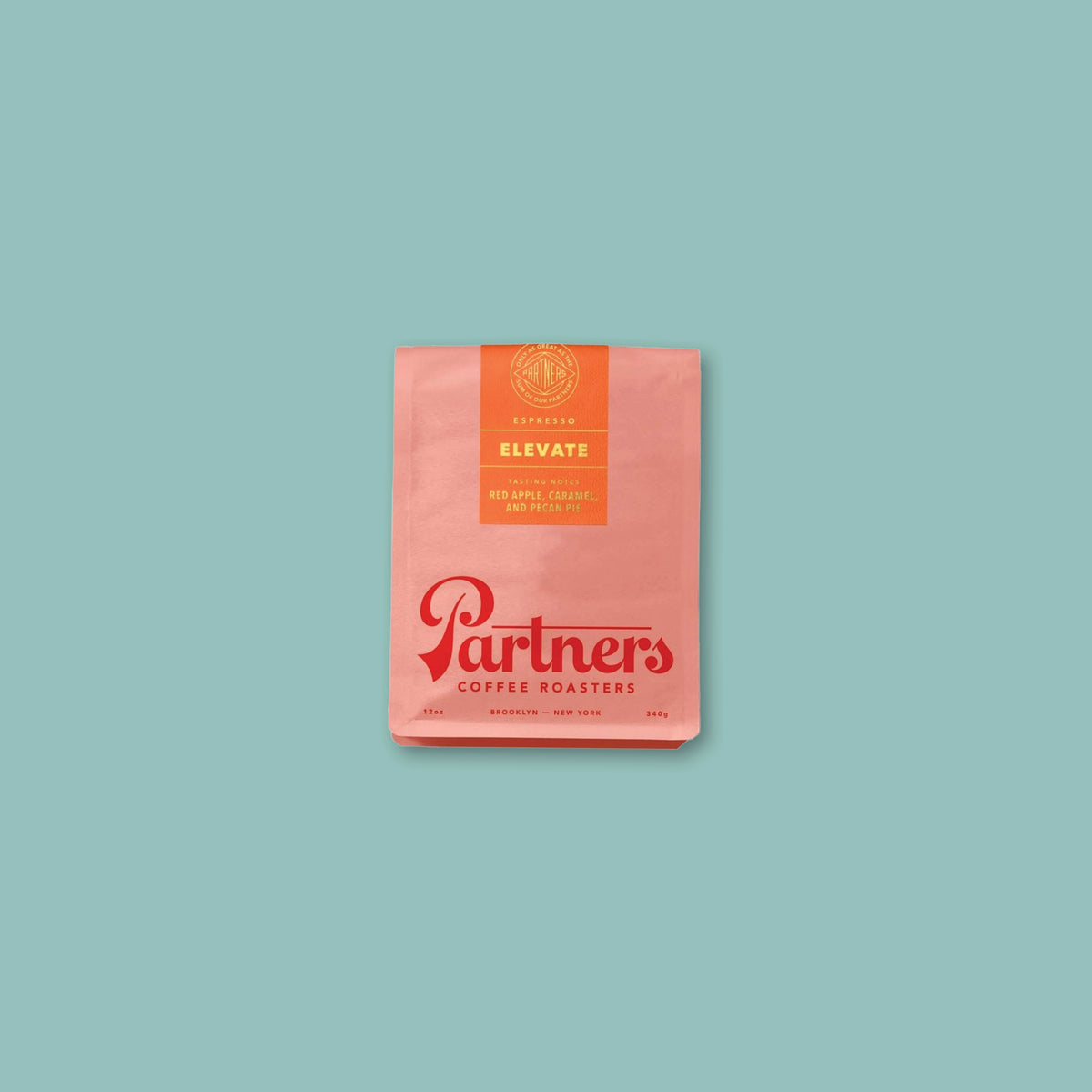 On a turquoise background sits a 12 oz. pink pouch of Elevate Whole Bean Coffee from Partners Coffee Roasters.