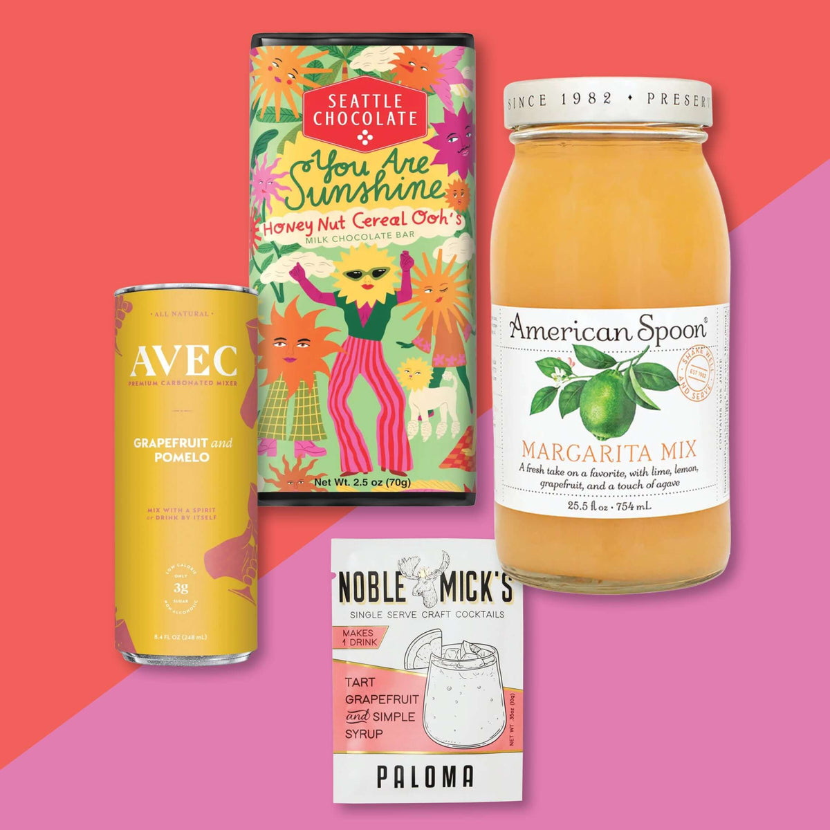On a raspberry pink background sits an assortment of cocktail mixes and a chocolate bar. There is a can of AVEC GRAPEFRUIT and POMELO PREMIUM CARBONATED MIX, a single serve packet from NOBLE MICK'S in a TART GRAPEFRUIT and SIMPLE SYRUP PALOMA FLAVOR, a bottle of American Spoon MARGARITA MIX, and a "You Are Sunsine," "Honey Nut Cereal Ooh's" MILK CHOCOLATE BAR. 